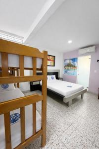 a bedroom with two bunk beds and a bathroom at Hotel Babilonia Boutique in Cúcuta +42 photos