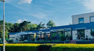 a blue building with umbrellas in front of it at Haus Herrenweide in Diepholz