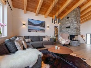 a living room with a couch and a table at Grebenzen Lodge 44 in Sankt Lambrecht