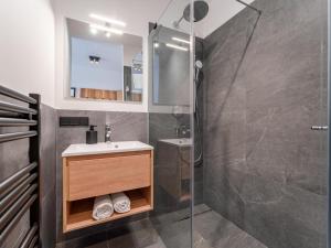 a bathroom with a shower and a sink and a mirror at Grebenzen Lodge 44 in Sankt Lambrecht +67 photos