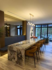 a large marble table in a room with chairs at Hangkhau Hotel in Yilan City