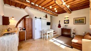 a kitchen and a living room with a table at La Pietra Dorata in Rapolano Terme