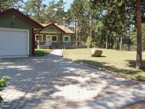 a house with a garage and a driveway at 8 person holiday home in Mönsterås in Mönsterås