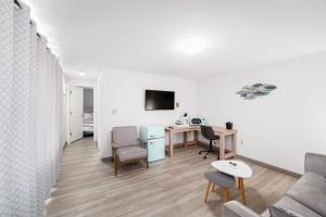a living room with a couch and a table at Founder's Brook Motel and Suites in Portsmouth