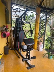 a gym with a chair in a room at Casa Mostaza-Ecolodge in Samaná