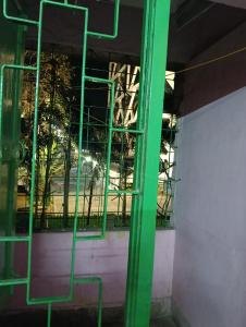 a green door in front of a building with a window at Hotel Swapnapuri in Bhubaneshwar