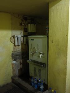 a kitchen with bottles of water in a room at Hotel Swapnapuri in Bhubaneshwar +21 photos
