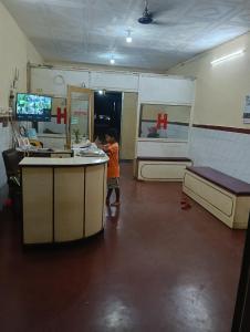 a young boy standing at a counter in a store at Hotel Swapnapuri in Bhubaneshwar