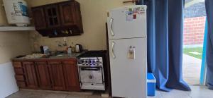 a kitchen with a white refrigerator and a stove at Cande in Parana