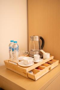 a wooden tray with a coffee maker and cups on a shelf at Riwaq Pyramids View Inn & Rooftop in Cairo