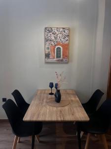 a wooden table with chairs and a vase on it at The Hidden Heaven in Chios