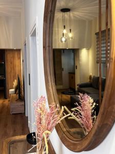 a large wooden mirror on a wall in a living room at The Hidden Heaven in Chios +3 photos
