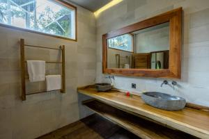 a bathroom with two sinks and a mirror at Sweet Escape - Boutique Hotel in Sidemen