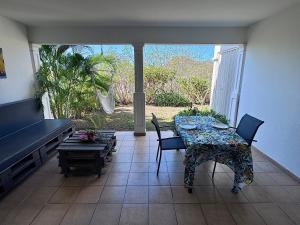 a living room with a table and chairs and a couch at Sxm Caribbean Nest in Saint Martin