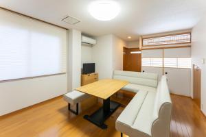 a living room with a table and a couch at 野町 庵 in Kanazawa