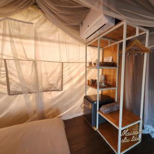 a bedroom with a bed in a tent at Maison Du Lac The Safari Tent in Wang Nam Khieo +2 photos