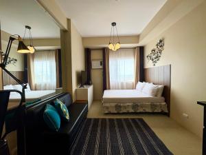 a hotel room with a bed and a couch at A city escape at the Avida Towers Aspira 1 in Cagayan de Oro