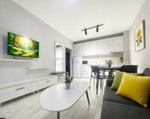 a living room with a couch and a table at ESKADA Apartments in Ahtopol