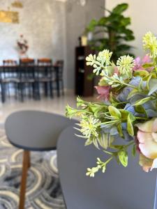 a vase filled with flowers sitting on a table at Swiss Home in Agadir