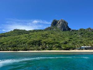 a view of a beach with a mountain in the background at Salote homestay in Lautoka