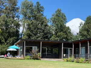 a house with a mountain in the background at Rukachohan in Pucón