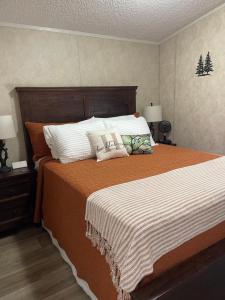 a bedroom with a large bed with two pillows on it at Huckleberry Hideaway in Minden