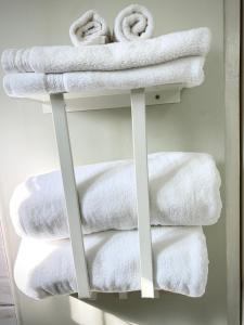 a pile of towels on a towel rack in a bathroom at Urban Loft in Falmouth +17 photos