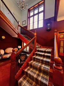 a staircase in a house with a plaid carpet at Willingham House Hotel in Willingham