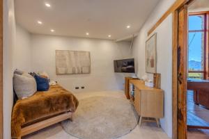 a bedroom with a bed and a tv on a wall at Lake Hawea View in Albert Town