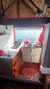 a kitchen with a stove and a sink in a boat at Check beth in Puerto Princesa City