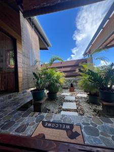 a courtyard with plants in front of a house at Manuia House in Bora Bora +11 photos