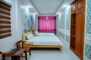 a bedroom with a bed and a pink window at An Gia Hotel in Quy Nhon