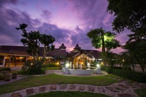 a night view of a house with lights in the yard at Luckswan Resort Chiang Rai - SHA Extra Plus in Chiang Rai