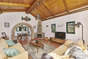 a living room with a couch and a table at Casa Brisa Do Rio, Malhada do São - Rural in Tavira