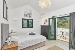 a bedroom with a bed and a sliding glass door at Casa Brisa Do Rio, Malhada do São - Rural in Tavira +37 photos