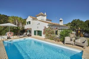 a villa with a swimming pool and a house at Casa Brisa Do Rio, Malhada do São - Rural in Tavira
