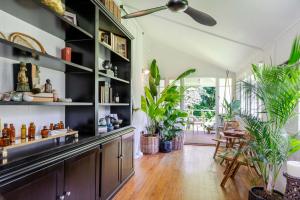 a kitchen with black shelves and potted plants at Charming Queenslander surrounded by Rainforest in Port Douglas