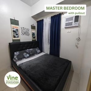 a bedroom with a black bed in a room at Vine Residences Staycation in Manila +38 photos