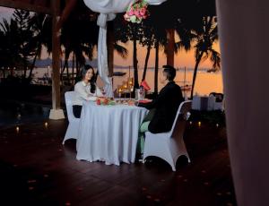 a man and woman sitting at a table in a restaurant at Laprima Hotel in Labuan Bajo +57 photos