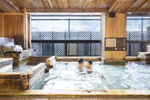 two children swimming in a hot tub at Ooedo Onsen Monogatari Yamashiro Saichoraku in Kaga +30 photos