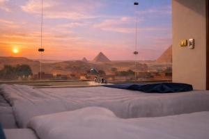 a bathroom with a tub with a view of pyramids at Pharaonic Pyramids Inn & jacuzzi in Cairo