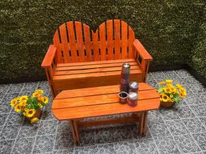a wooden bench with two candles sitting on it at Departamento Adrián in Mar del Plata
