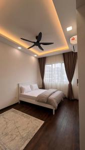 a bedroom with a bed with a ceiling fan at HOMESTAY WITH 2 BEDROOMS IN NILAI for Malaysian traveler in Nilai
