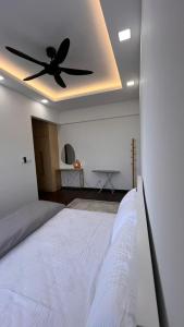 a bedroom with a bed with a ceiling fan at HOMESTAY WITH 2 BEDROOMS IN NILAI for Malaysian traveler in Nilai