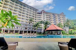 a large hotel with a pool and a gazebo at Laprima Hotel in Labuan Bajo
