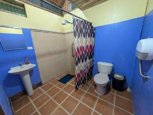 a bathroom with a toilet and a sink at Hotel La Gamba Rainforest Lodge in Golfito