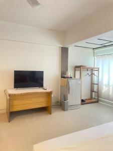 a room with a bed and a refrigerator at A Day Rayong in Ban Pa Khan