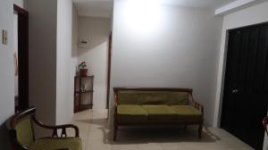 a living room with a couch and two chairs at Departamento Macas in Macas
