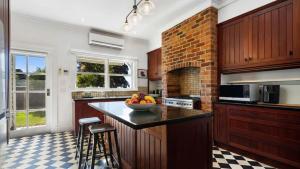 a kitchen with a bowl of fruit on a counter at Charming Heritage Retreat in Sale