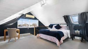 a bedroom with a bed and a table and a window at Charming Heritage Retreat in Sale